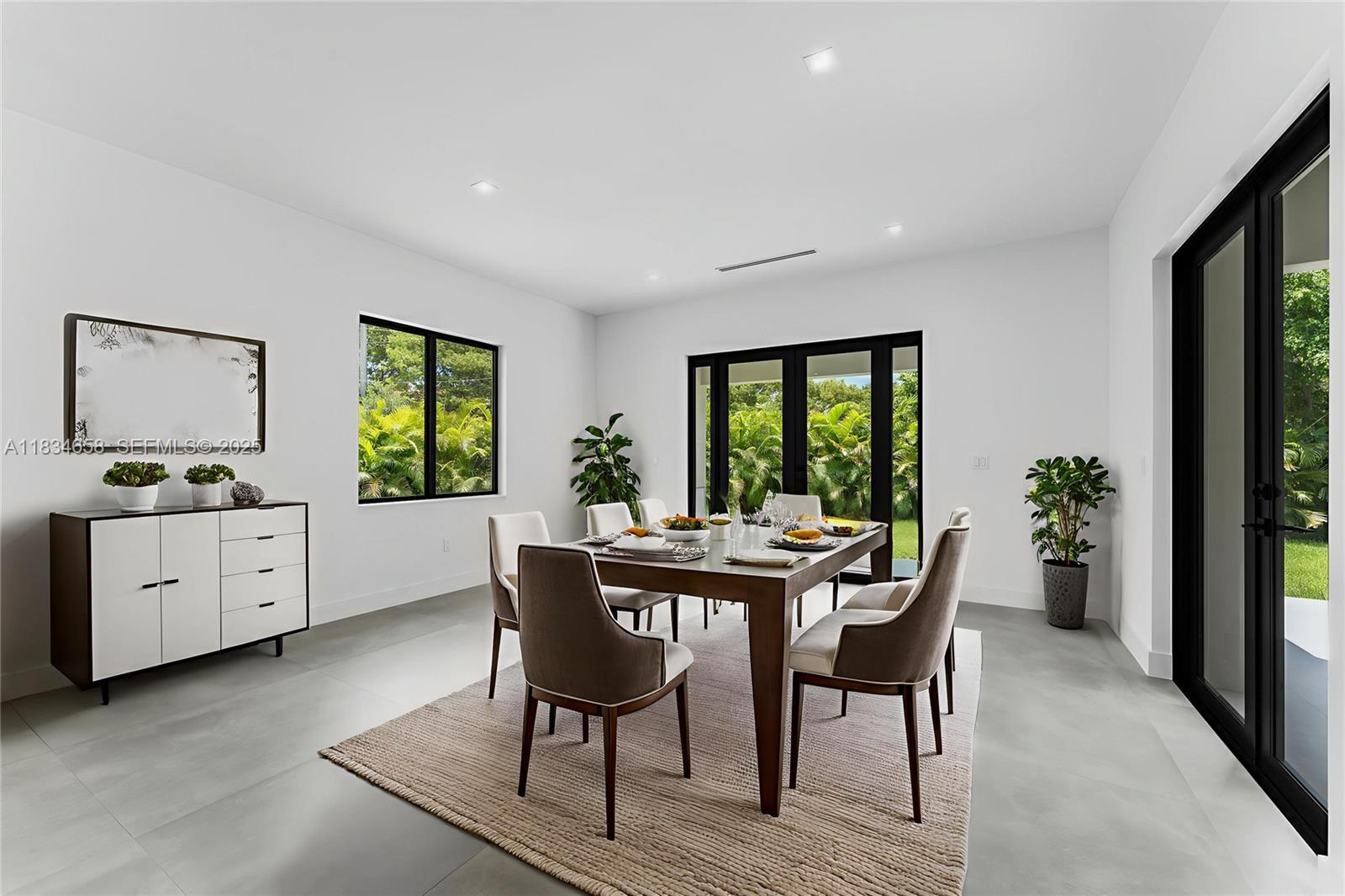 8220 Southwest 193rd Terrace Cutler Bay, FL 33157 - Photo 6 of 59 a view of a dining room with furniture window and wooden floor