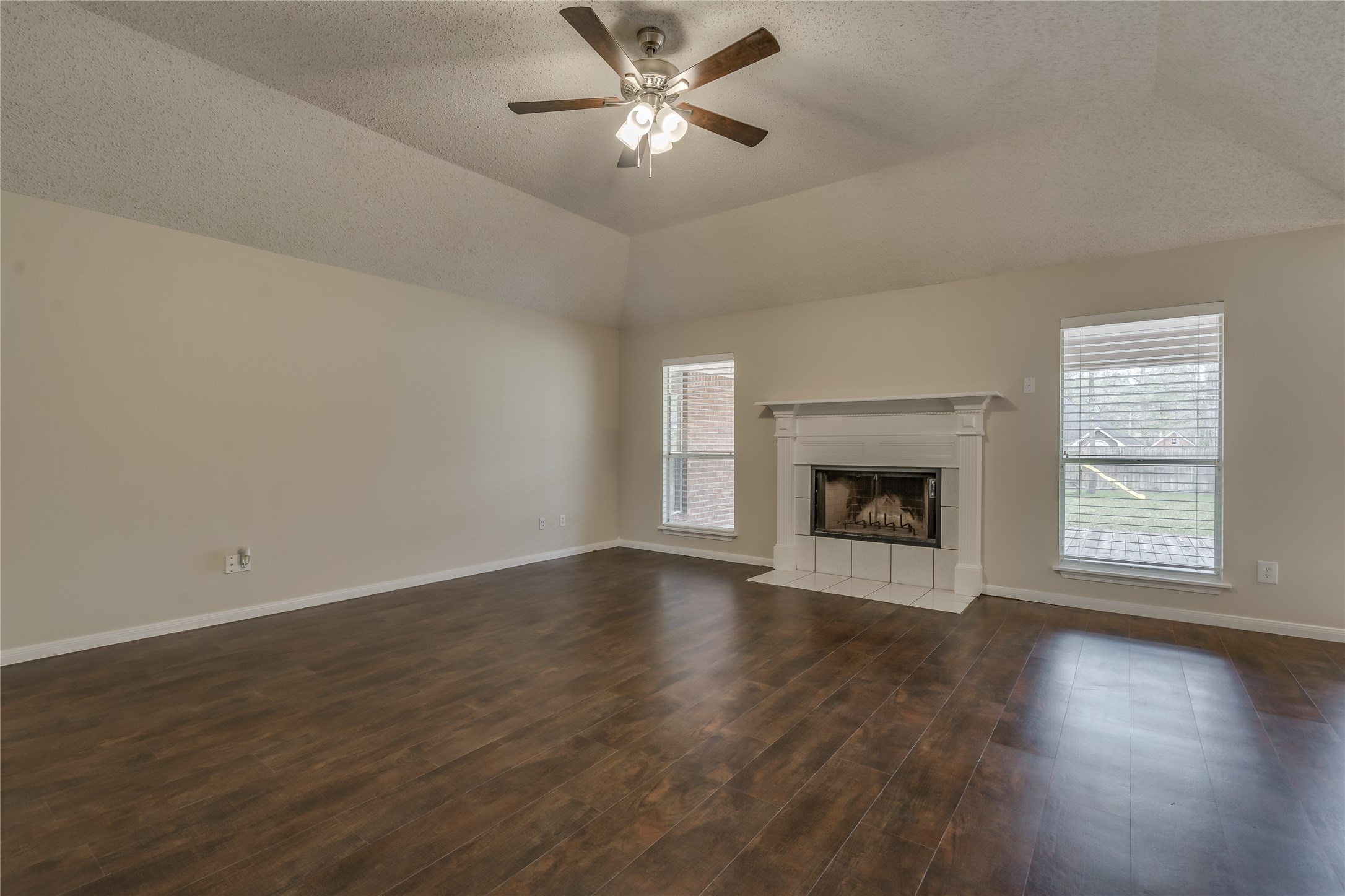 2460 Pebblebrook Circle Conroe, TX 77384 - Photo 7 of 27 Spacious family room with high ceilings and traditional fireplace