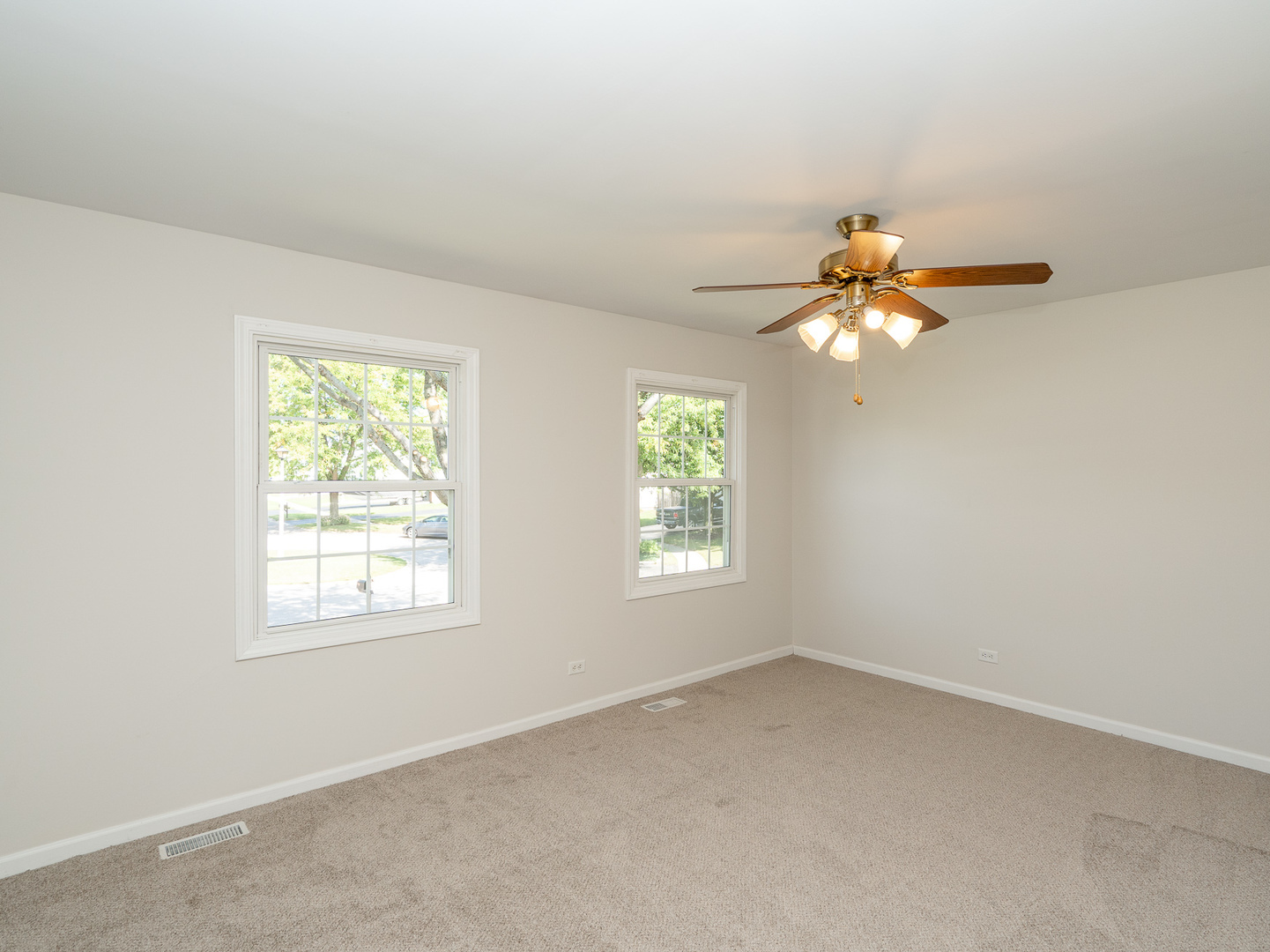 446 Hunters Way Fox River Grove, IL 60021 - Photo 17 of 23 an empty room with windows and chandelier fan