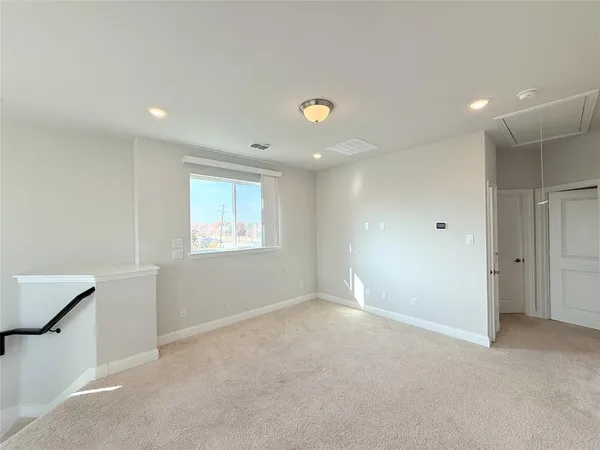 an empty room with windows and closet