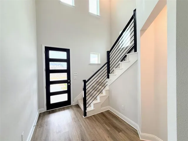 a view of entryway with stairs and wooden floor