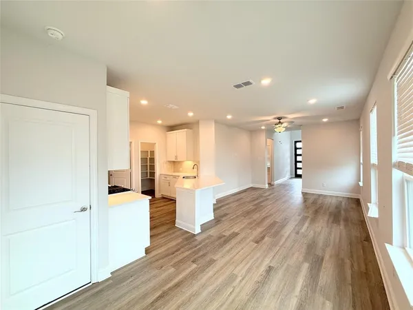 a view of a kitchen with wooden floor