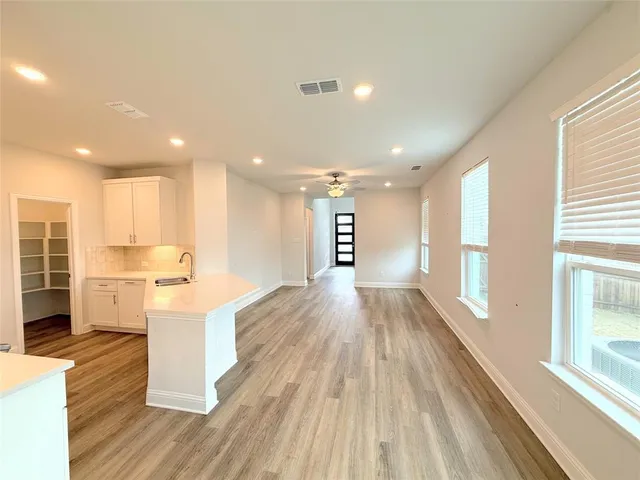 a view of kitchen with furniture and wooden floor