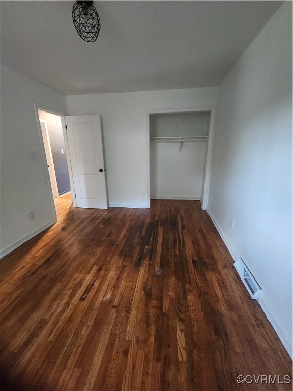 514 Conley Road Richmond, VA 23227 - Photo 12 of 15 Unfurnished bedroom featuring a closet and dark ha