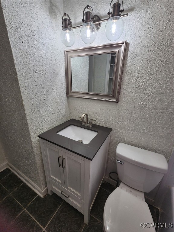 514 Conley Road Richmond, VA 23227 - Photo 5 of 15 Bathroom featuring toilet, vanity, and tile patter