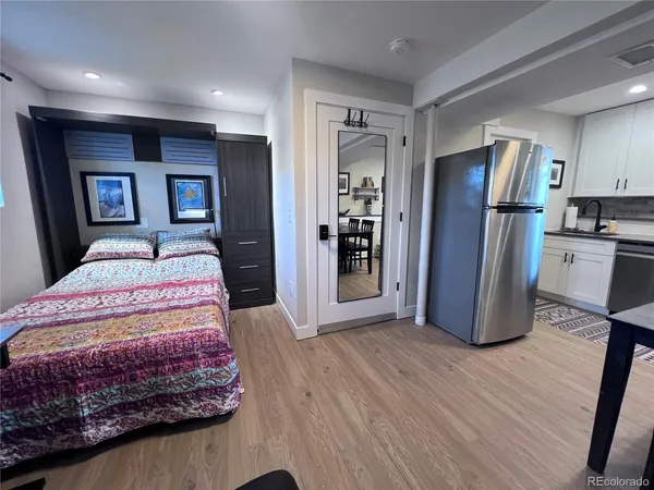 a bed room with a bed and a television