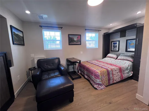 a bedroom with a bed couch and a window