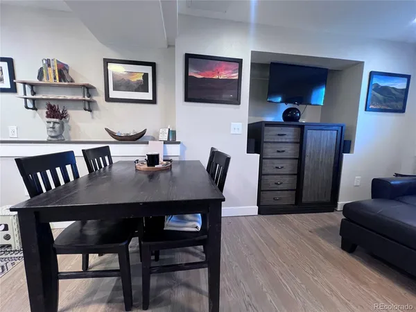 a view of a dining room with furniture and wooden floor