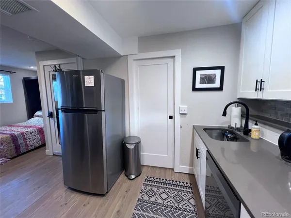 a kitchen with a refrigerator and a sink