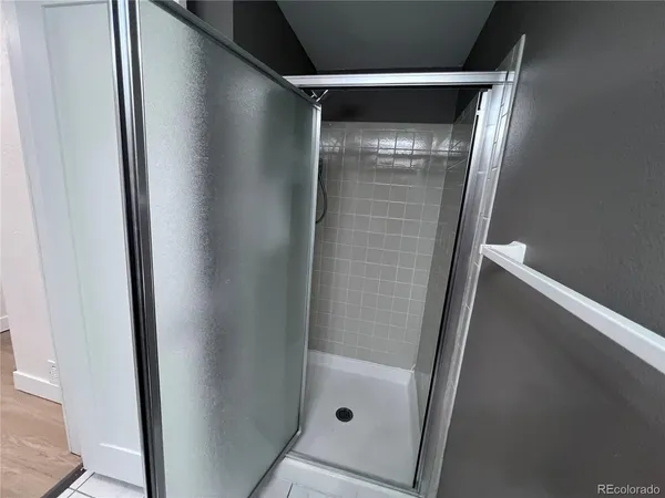 a bathroom with a glass door shower