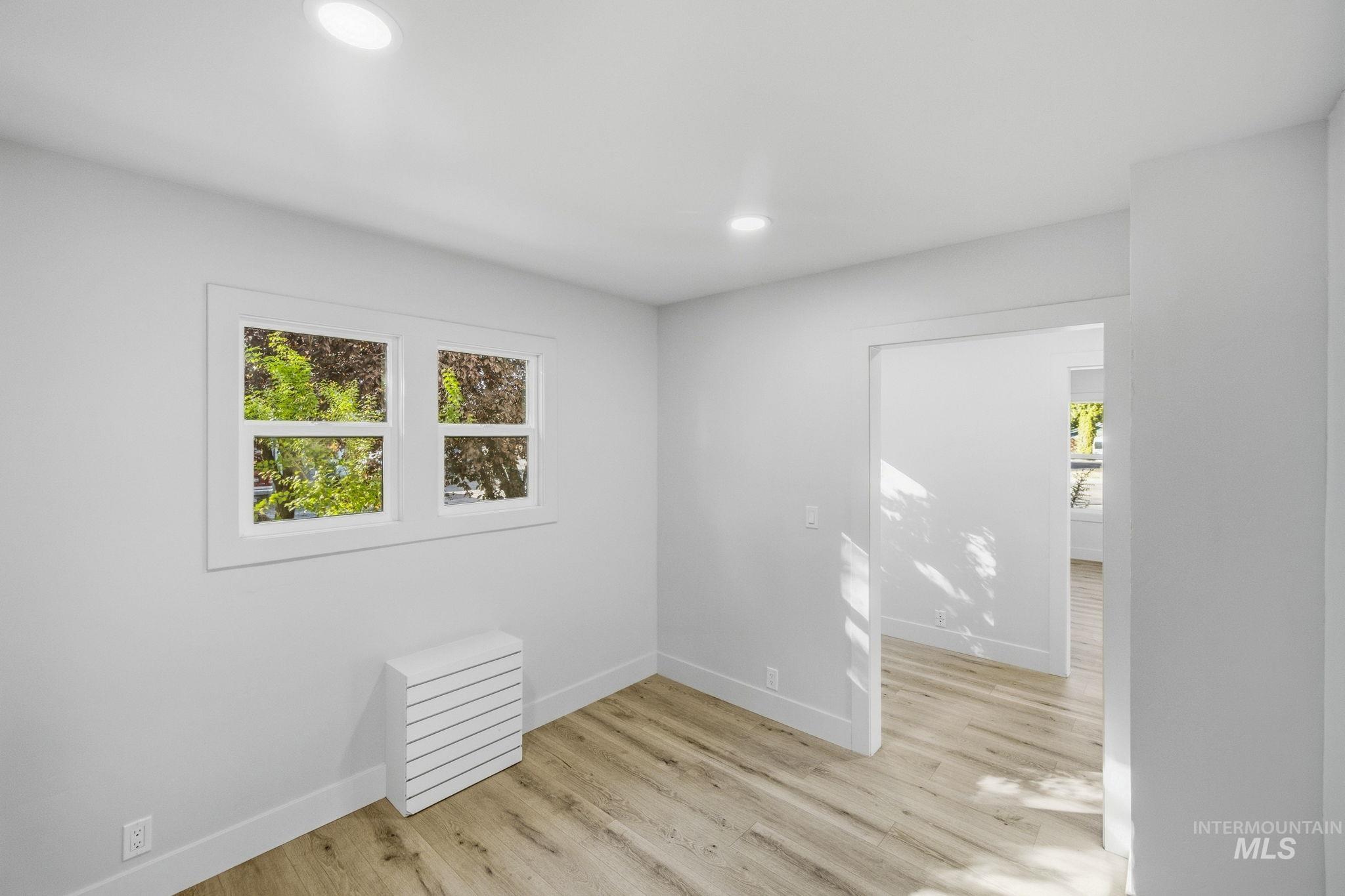 3113 West Overland Road Boise, ID 83705 - Photo 32 of 40 Recessed lighting, wood-finish flooring, white trim, and a window with a white frame