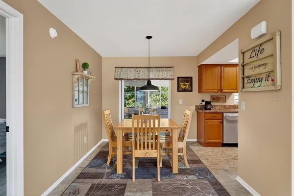 a dining room with furniture a window and stainless steel appliances