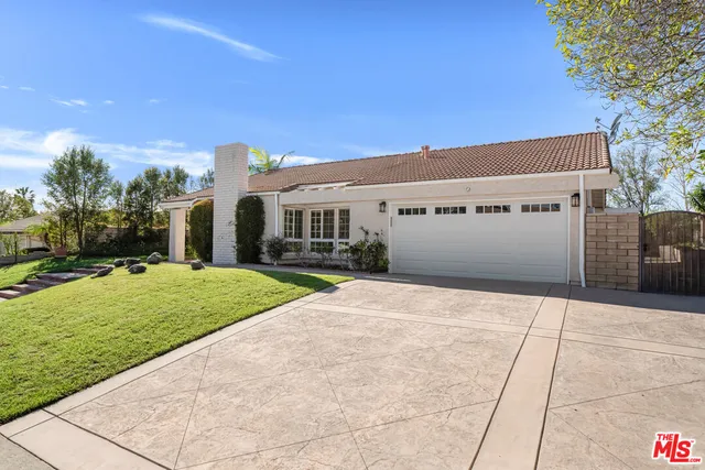 a front view of a building with a yard