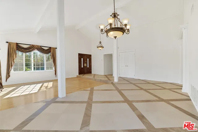 a view of an entryway with wooden floor and windows