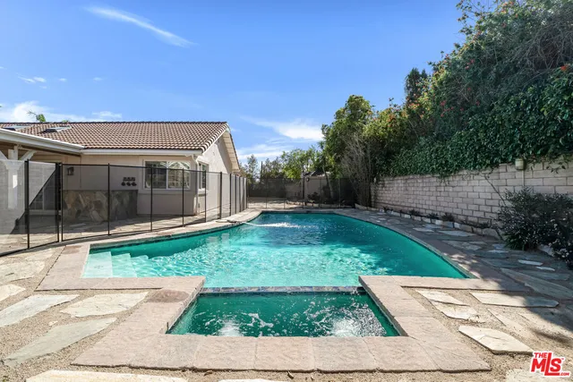 a view of backyard with potted plants and a fountain