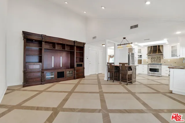 a view of a living room a kitchen with furniture and a refrigerator
