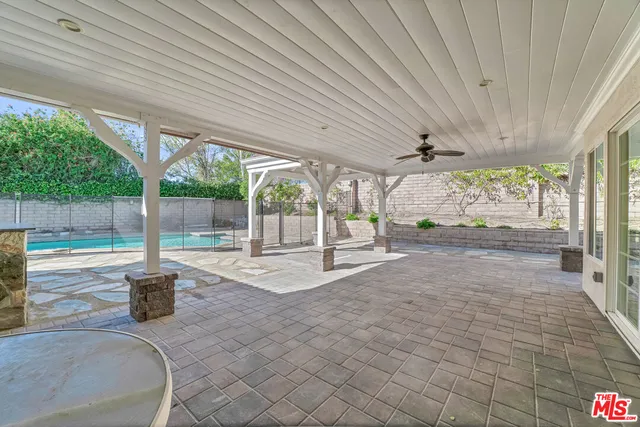a view of a porch with furniture and garden