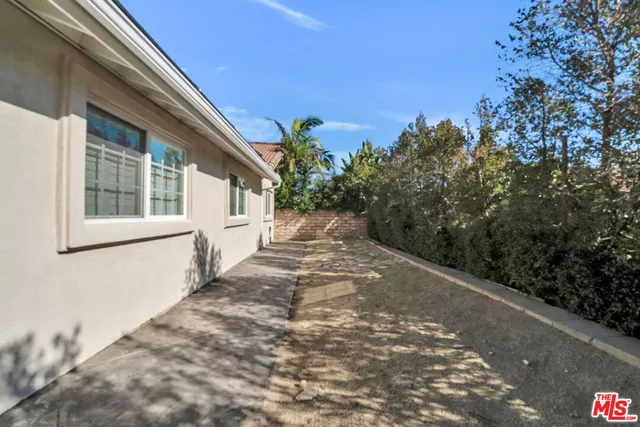 a view of a backyard with large trees