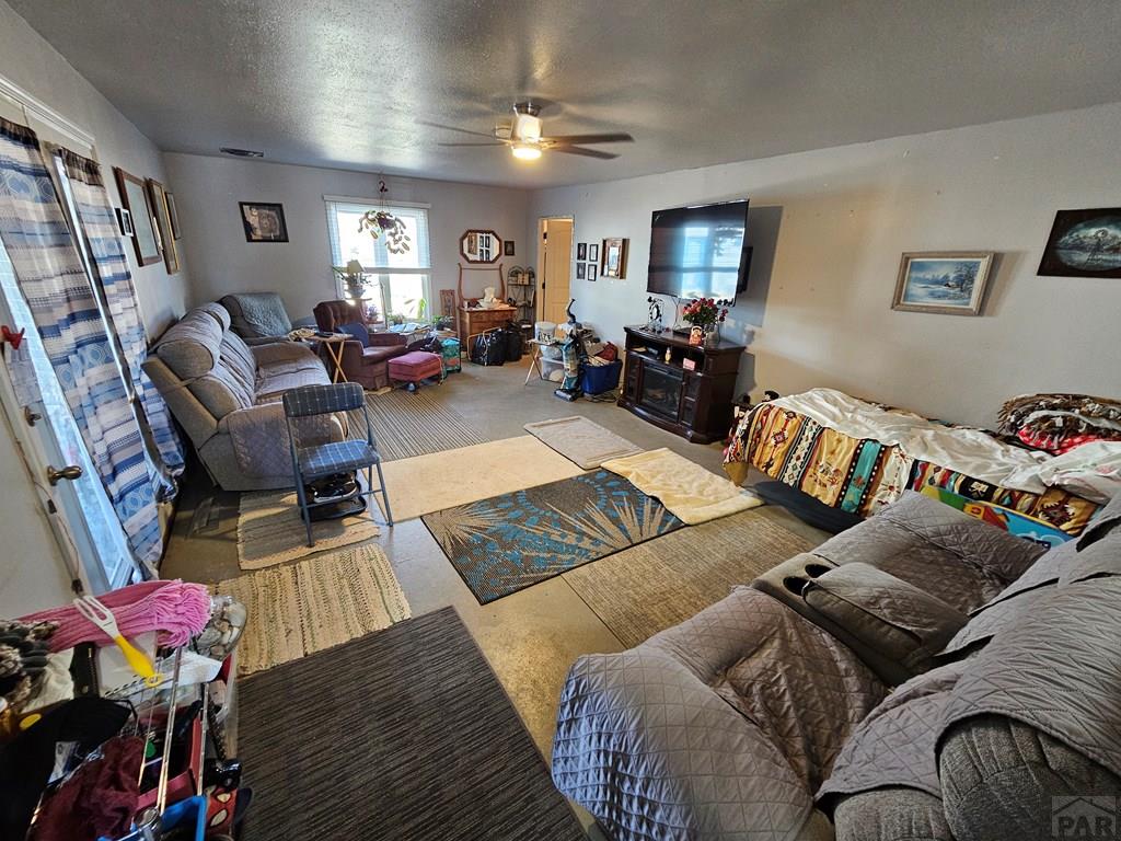 233 East 5th Avenue Springfield, CO 81073 - Photo 12 of 30 a living room with furniture chess board and wooden floor