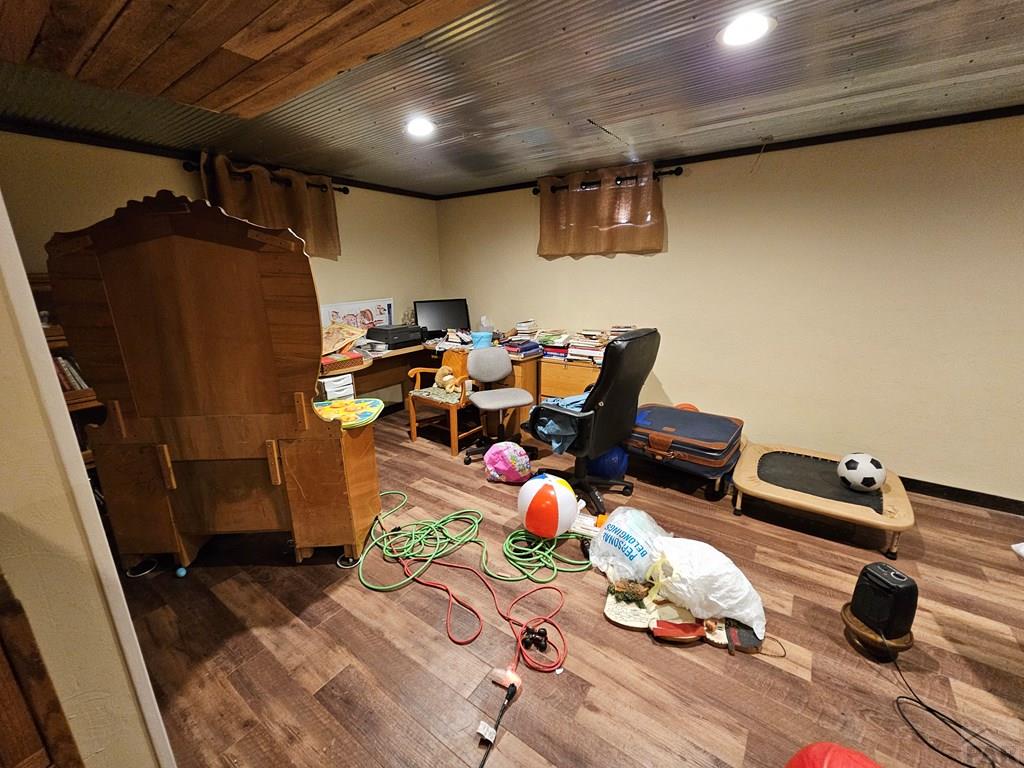 233 East 5th Avenue Springfield, CO 81073 - Photo 17 of 30 a room with wooden floor and gym equipment