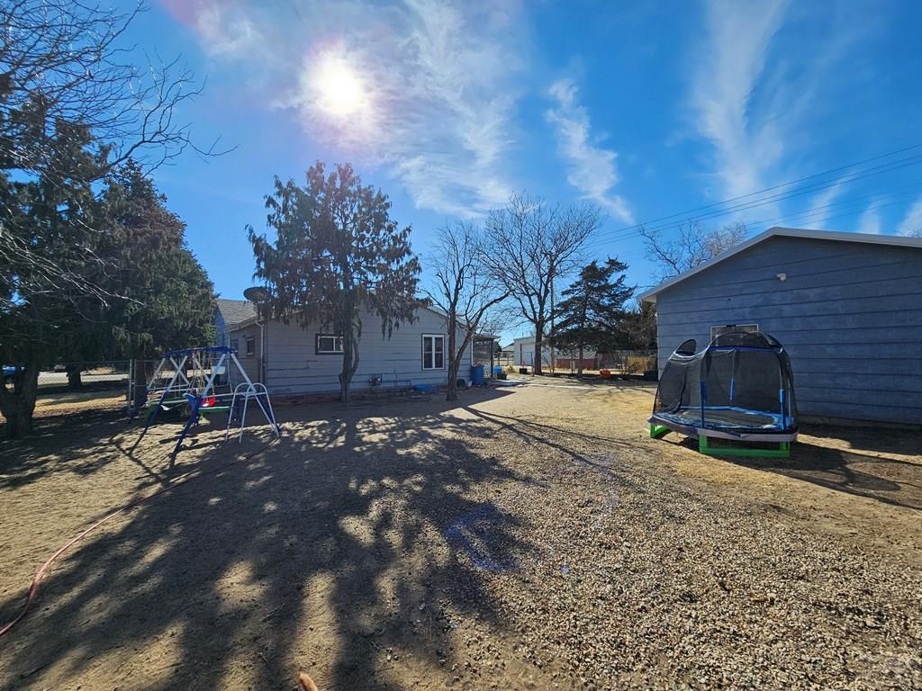 233 East 5th Avenue Springfield, CO 81073 - Photo 28 of 30 a view of a backyard with table and chairs and a fire pit