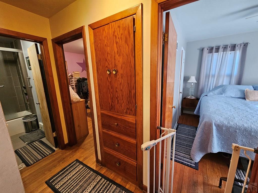 233 East 5th Avenue Springfield, CO 81073 - Photo 3 of 30 a view of a hallway with wooden floor and furniture