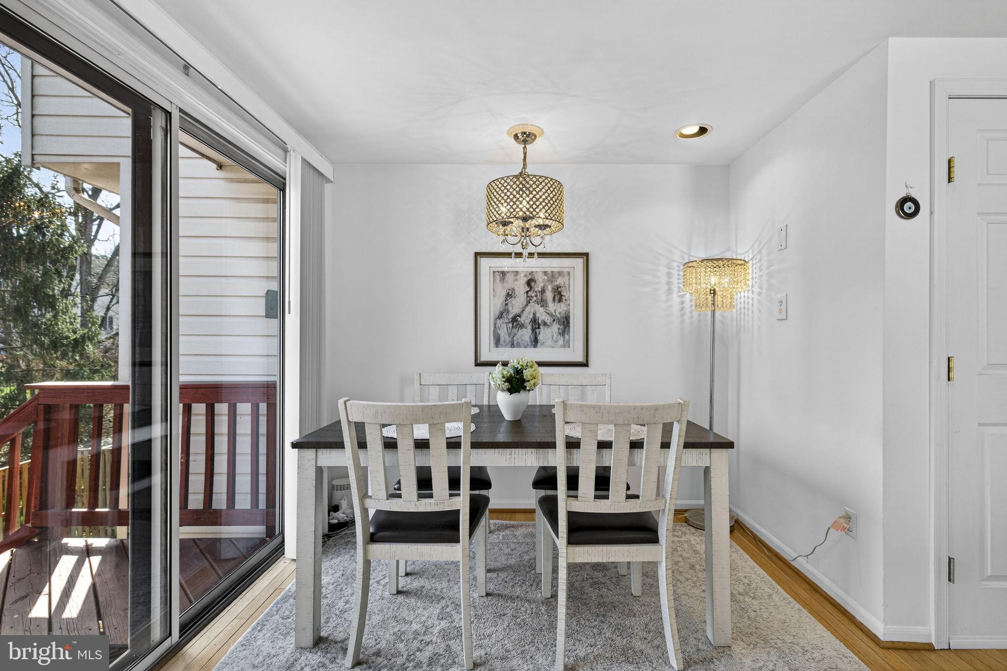 45430 Gable Square Sterling, VA 20164 - Photo 19 of 52 a dining room with furniture a chandelier and wooden floor