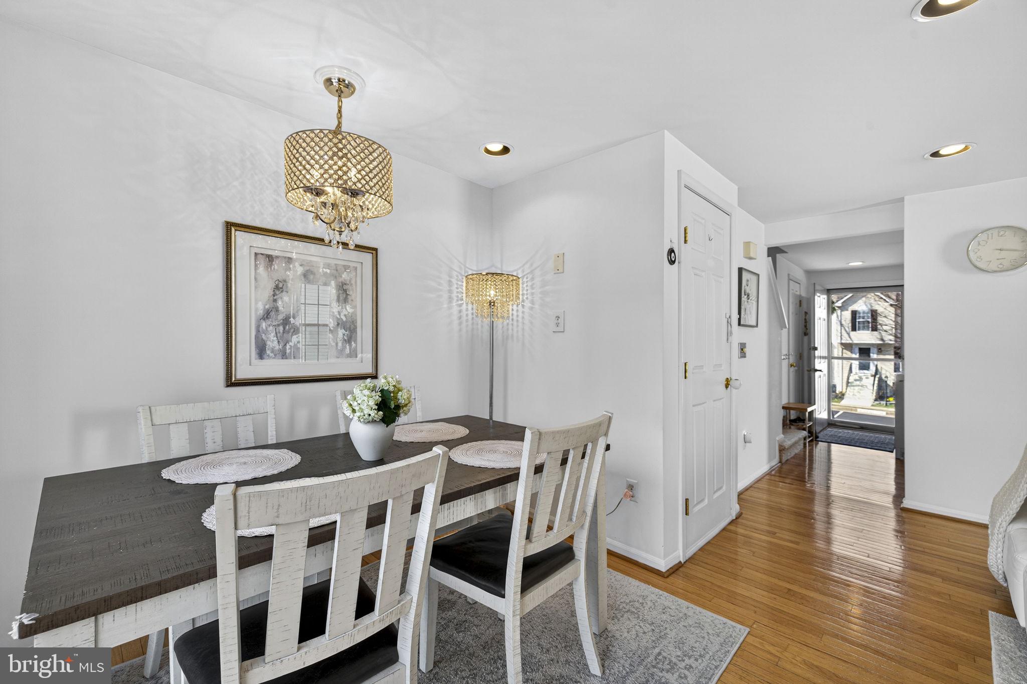 45430 Gable Square Sterling, VA 20164 - Photo 21 of 52 a view of a dining room with furniture wooden floor and chandelier