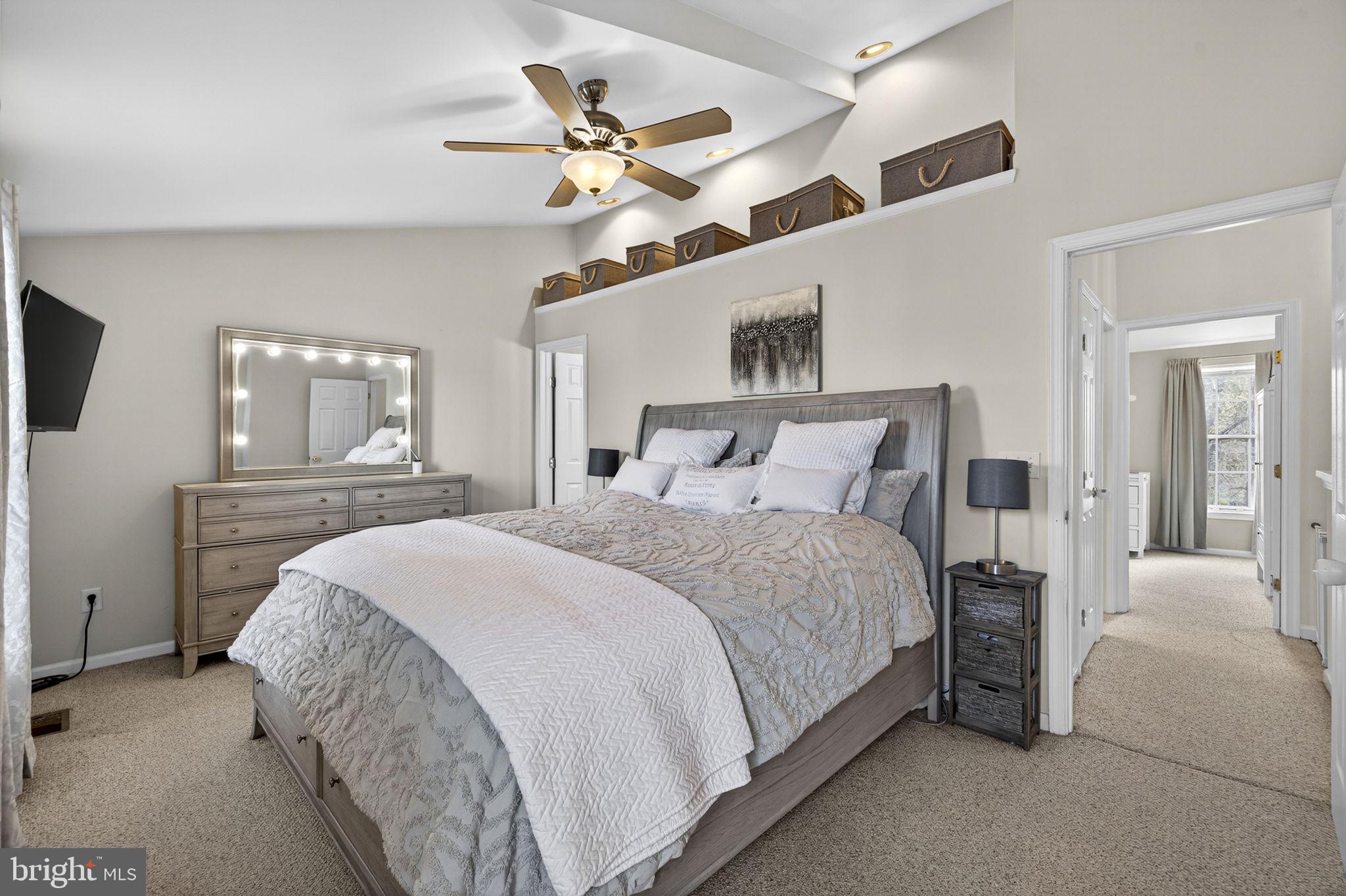 45430 Gable Square Sterling, VA 20164 - Photo 23 of 52 a bedroom with a large bed and a chandelier