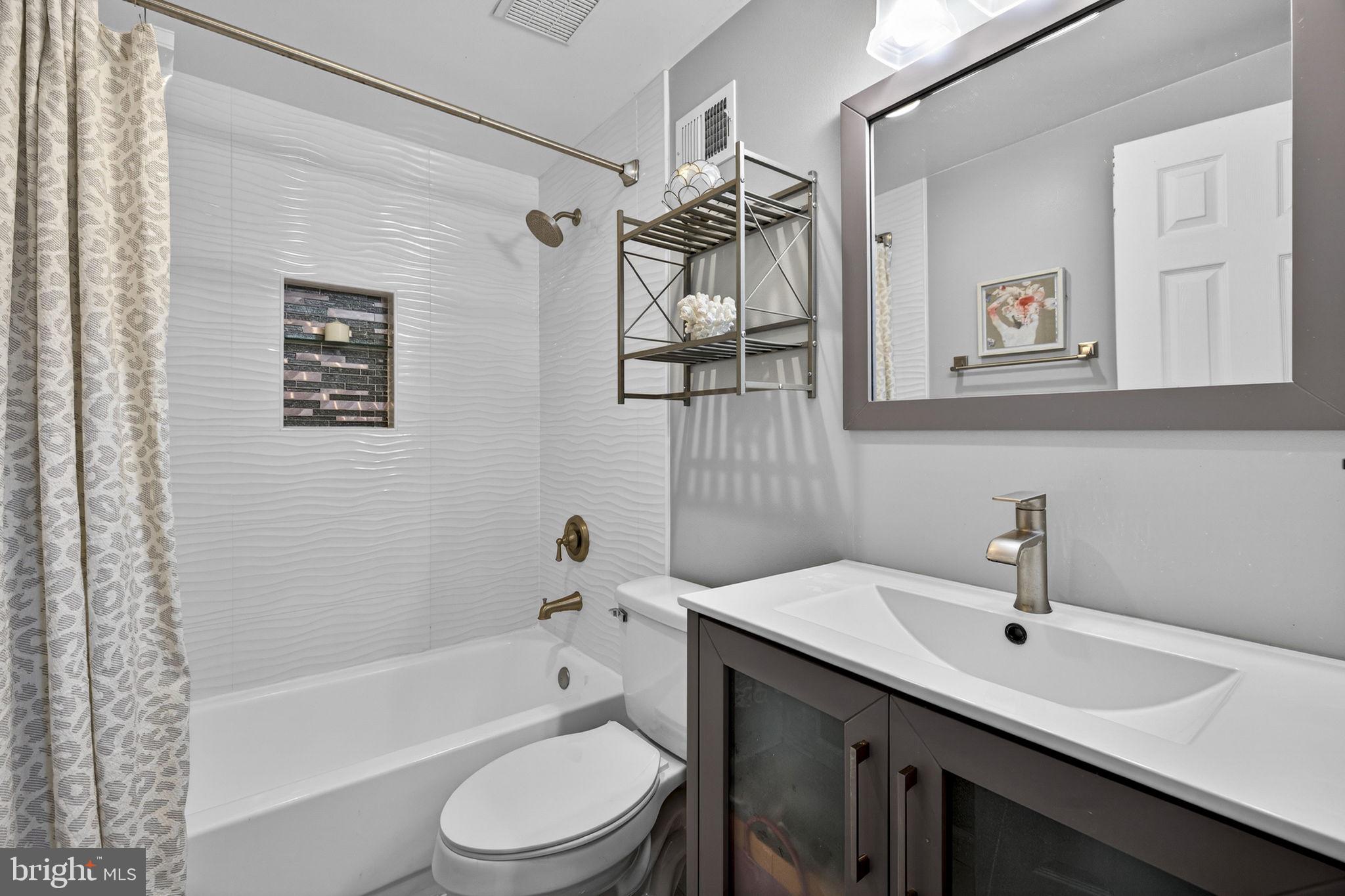 45430 Gable Square Sterling, VA 20164 - Photo 27 of 52 a bathroom with a sink a toilet and shower