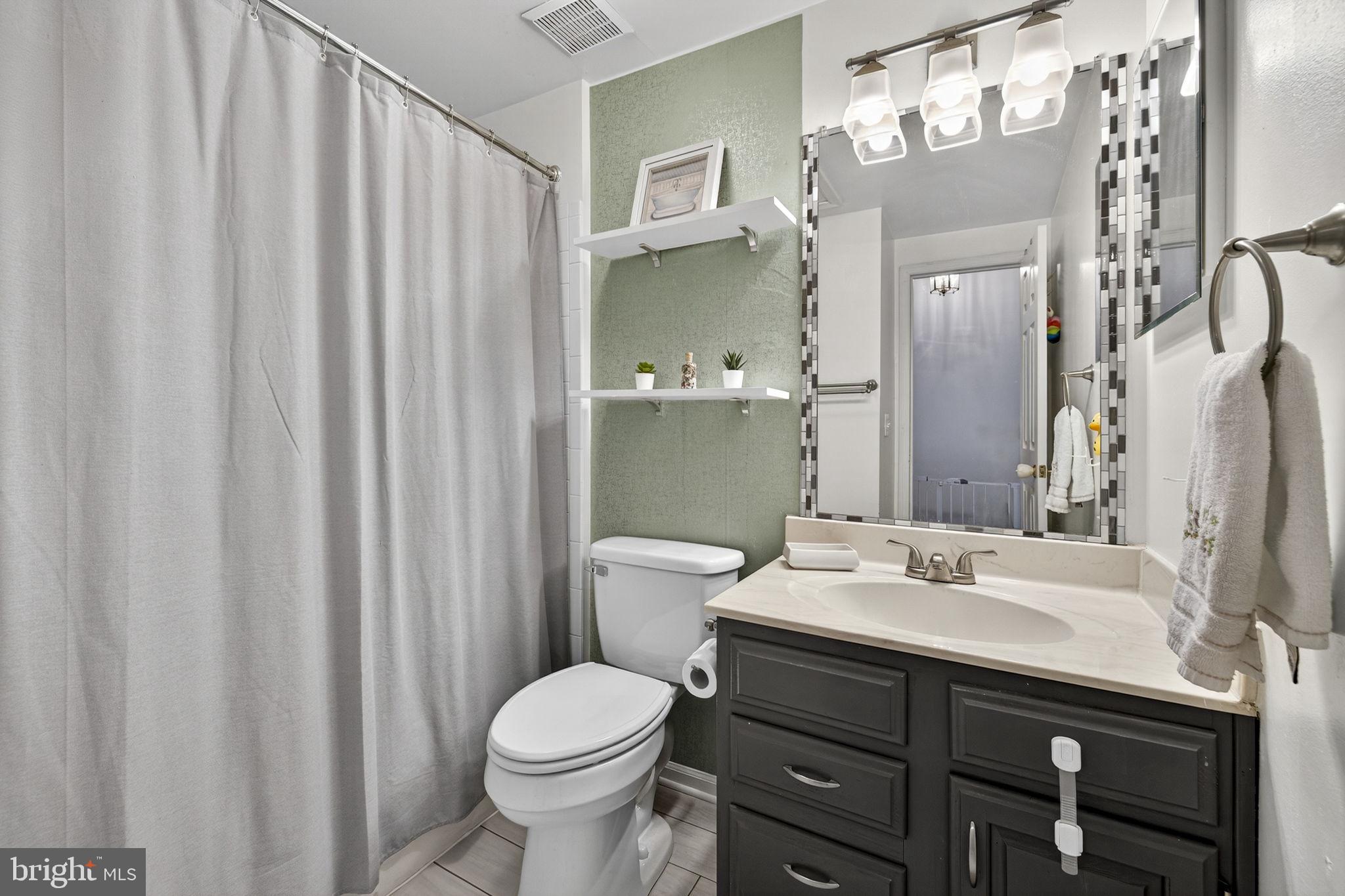45430 Gable Square Sterling, VA 20164 - Photo 33 of 52 a bathroom with a sink a toilet and shower curtain
