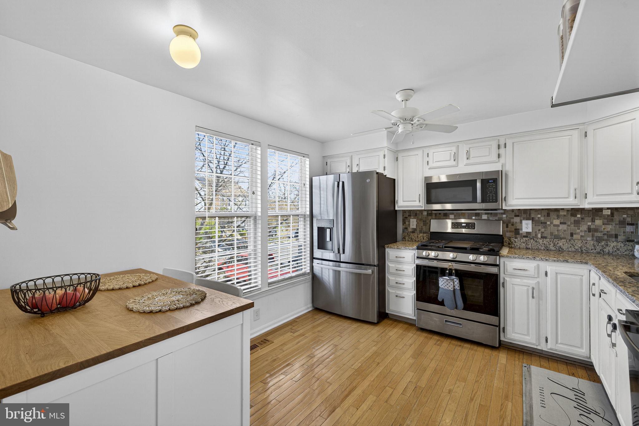 45430 Gable Square Sterling, VA 20164 - Photo 6 of 52 a kitchen with granite countertop stainless steel appliances a stove top oven a sink and a granite counter tops