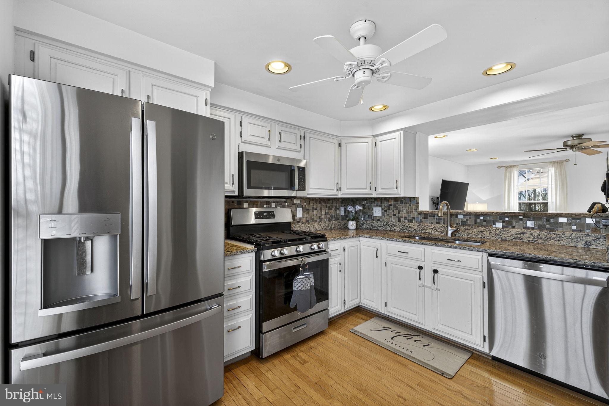 45430 Gable Square Sterling, VA 20164 - Photo 9 of 52 a kitchen with granite countertop a refrigerator oven a sink dishwasher and a stove