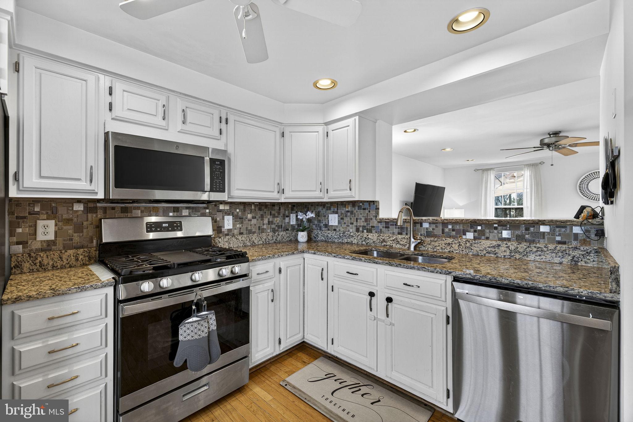 45430 Gable Square Sterling, VA 20164 - Photo 10 of 52 a kitchen with granite countertop a stove sink and cabinets