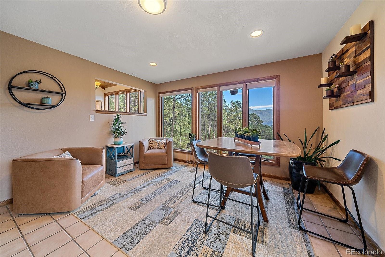 4059 Histead Way Evergreen, CO 80439 - Photo 17 of 37 a dining room with furniture and window