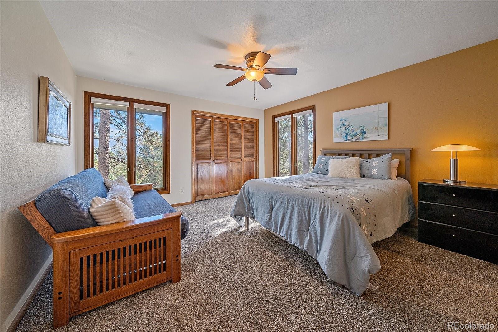 4059 Histead Way Evergreen, CO 80439 - Photo 26 of 37 a bedroom with a bed and a window