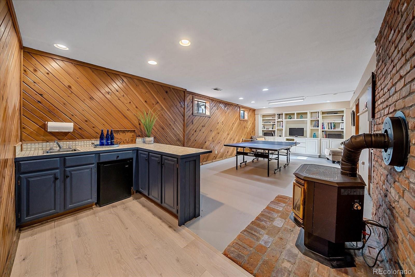 4059 Histead Way Evergreen, CO 80439 - Photo 29 of 37 a open kitchen with stainless steel appliances granite countertop a barbecue grill and couches chair with garden view