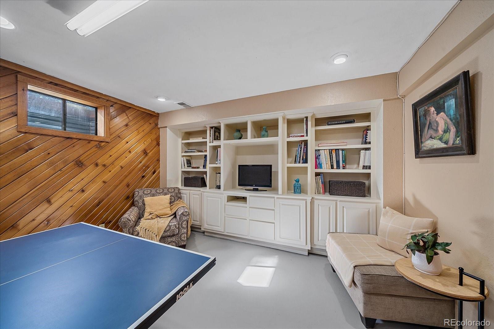 4059 Histead Way Evergreen, CO 80439 - Photo 31 of 37 a living room with furniture and a flat screen tv