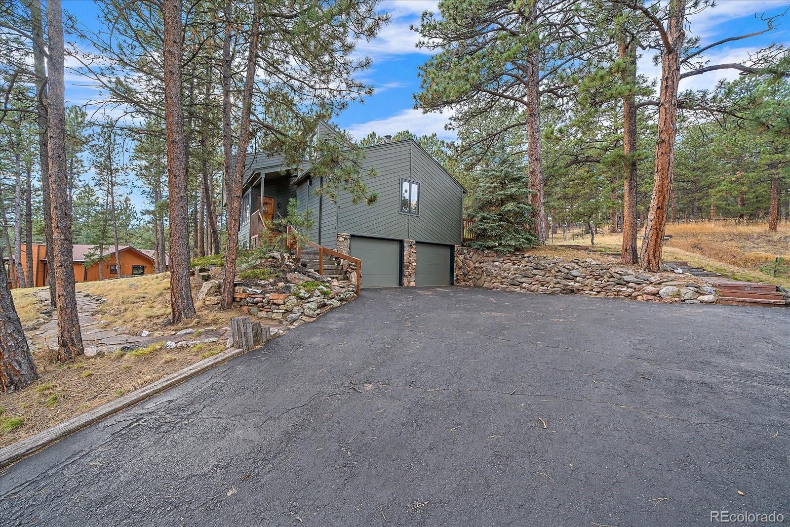 4059 Histead Way Evergreen, CO 80439 - Photo 36 of 37 a view of a house with a yard and tree