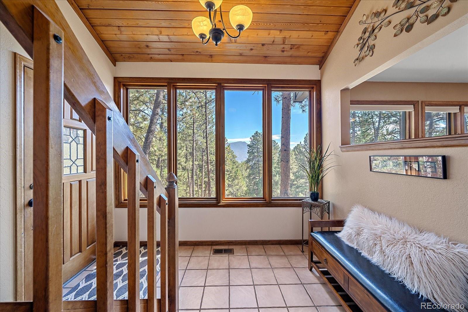 4059 Histead Way Evergreen, CO 80439 - Photo 4 of 37 a living room with furniture and a large window
