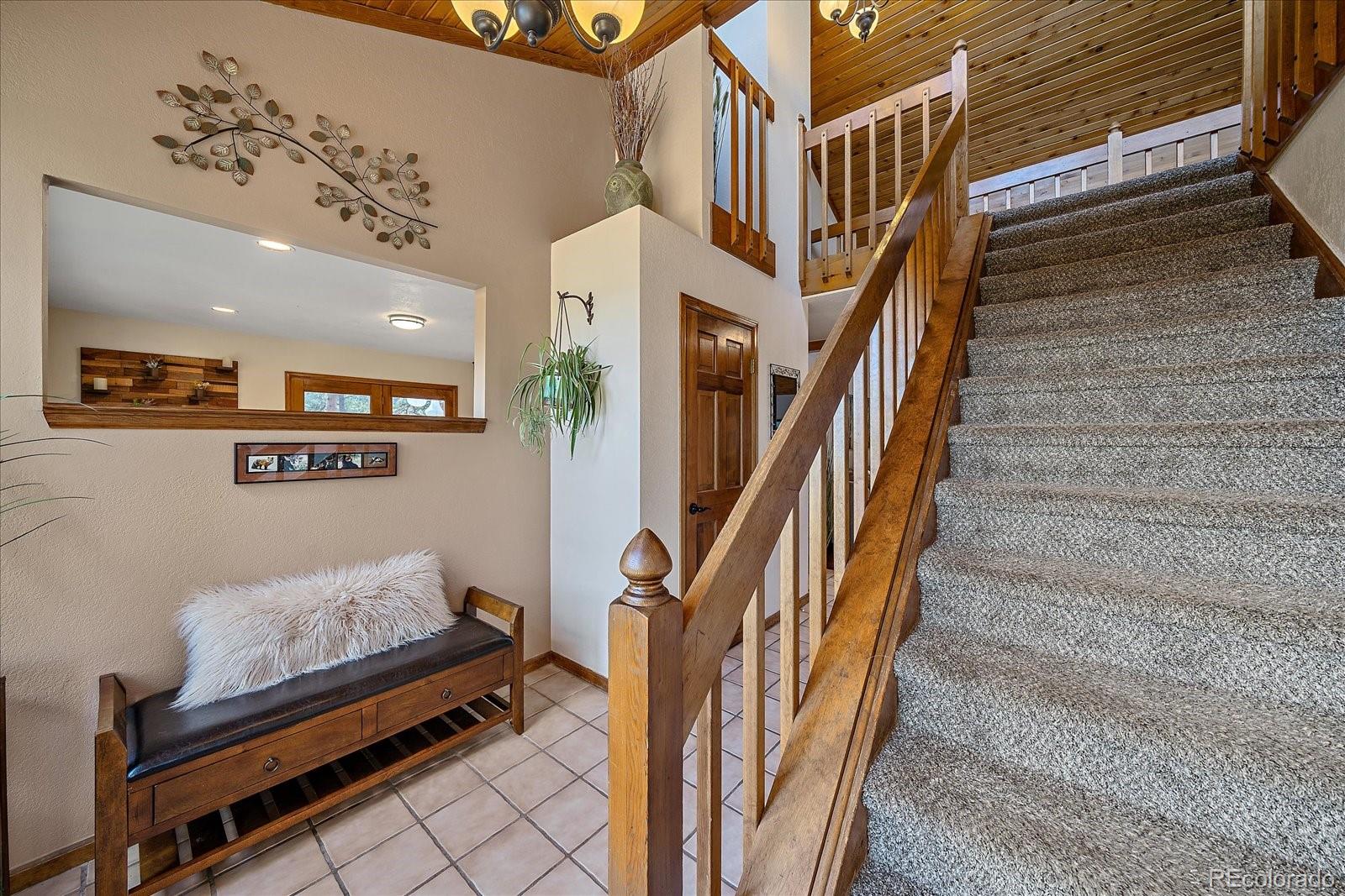 4059 Histead Way Evergreen, CO 80439 - Photo 5 of 37 a view of staircase with lots of frames on wall and a potted plant