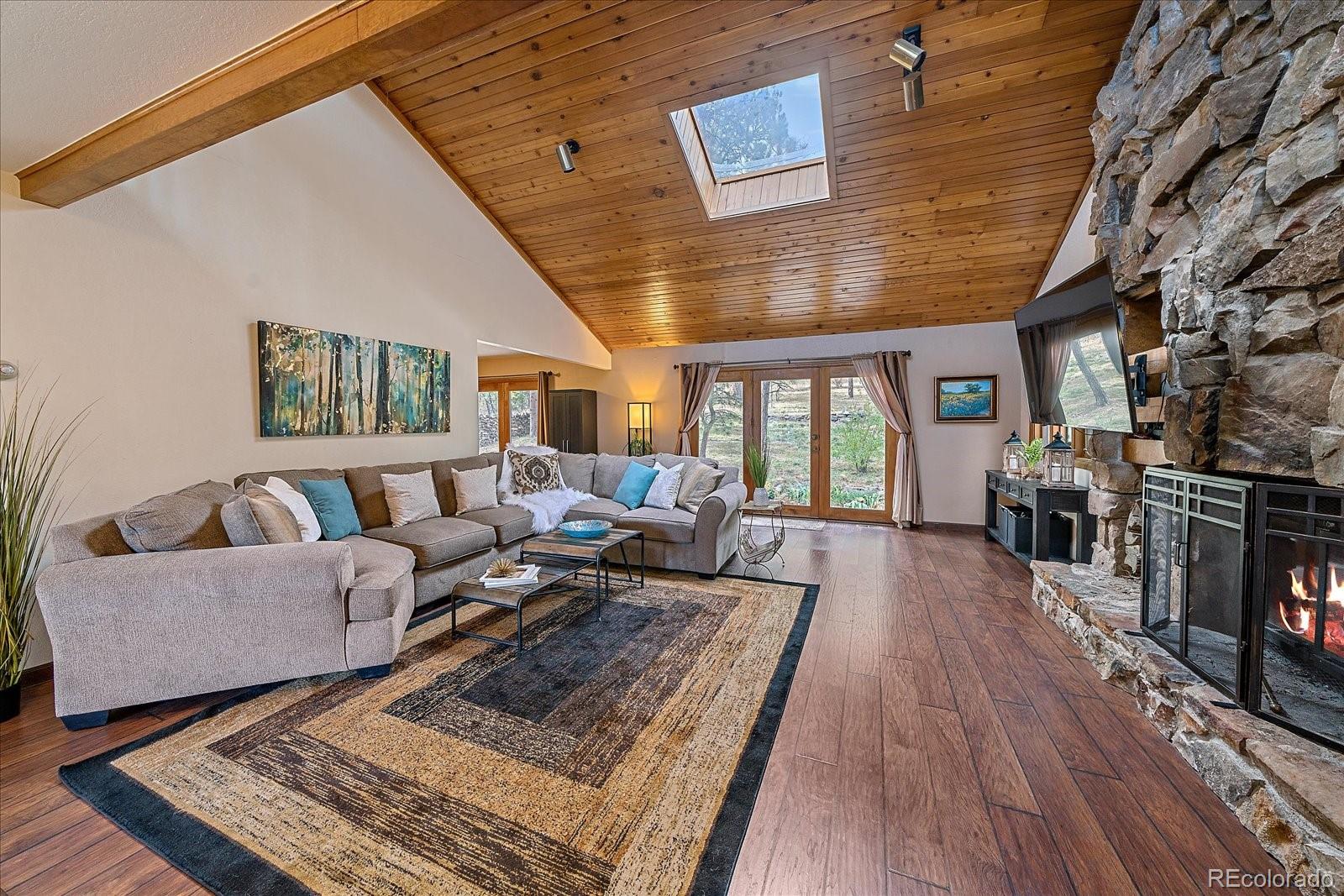 4059 Histead Way Evergreen, CO 80439 - Photo 7 of 37 a living room with furniture and a rug