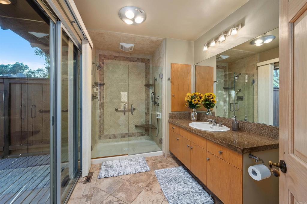 16522 Orchard Bend Road Poway, CA 92064 - Photo 12 of 26 a bathroom with a granite countertop sink mirror and shower