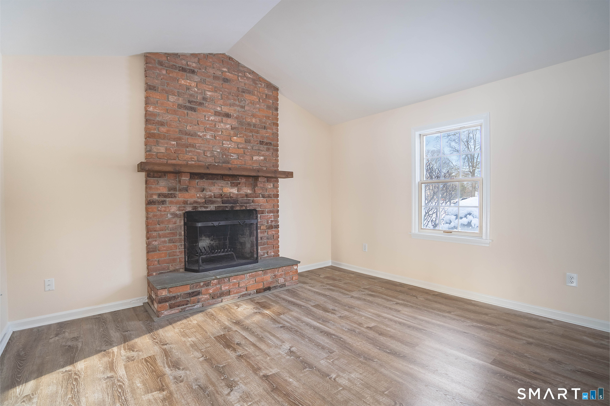 4 Currycross Road, Unit 4 Madison, CT 06443 - Photo 8 of 29 a view of an empty room with wooden floor fireplace and a window