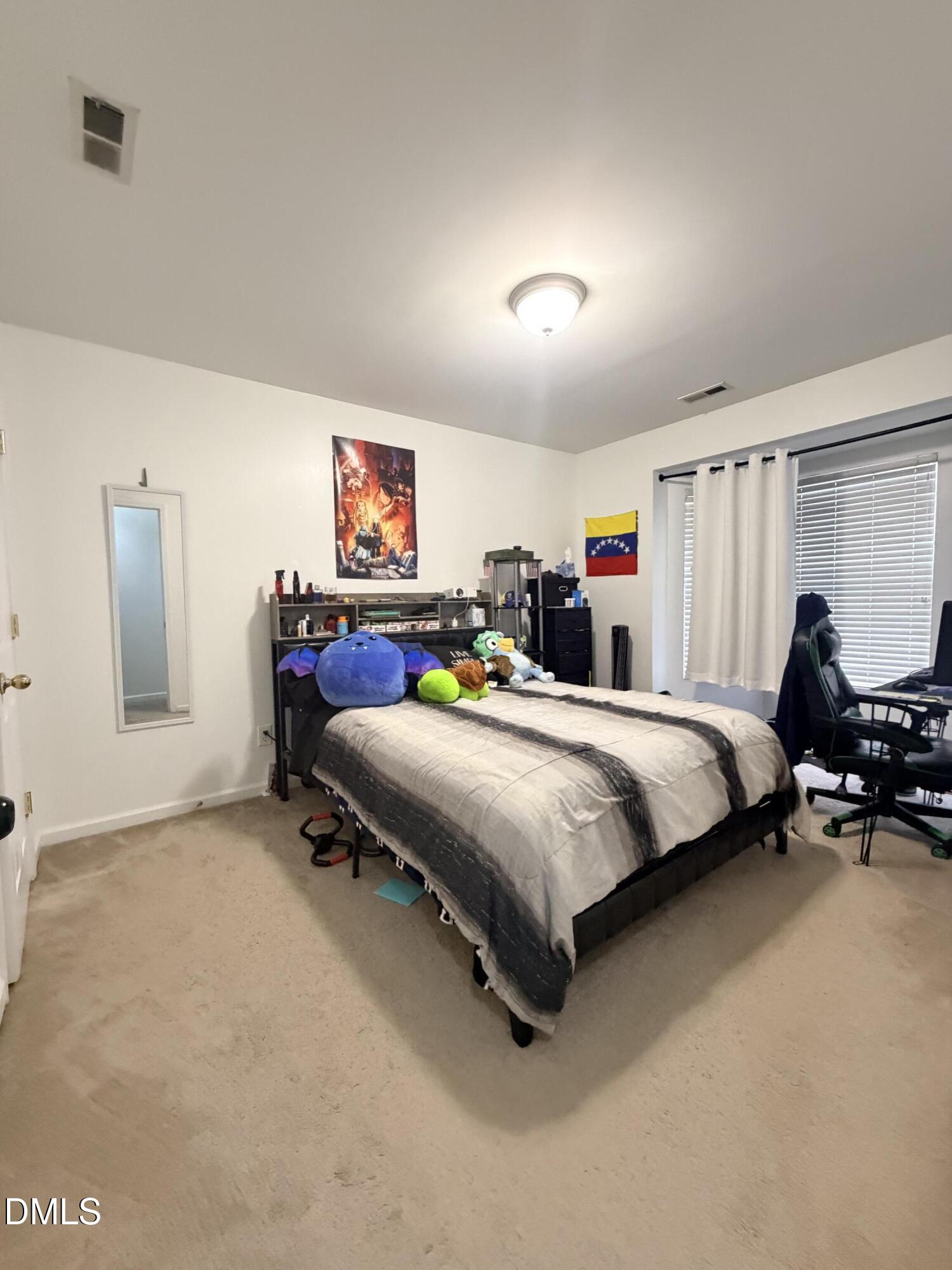 5345 Glen Canyon Road Raleigh, NC 27616 - Photo 13 of 21 a bed room with a bed and a chair