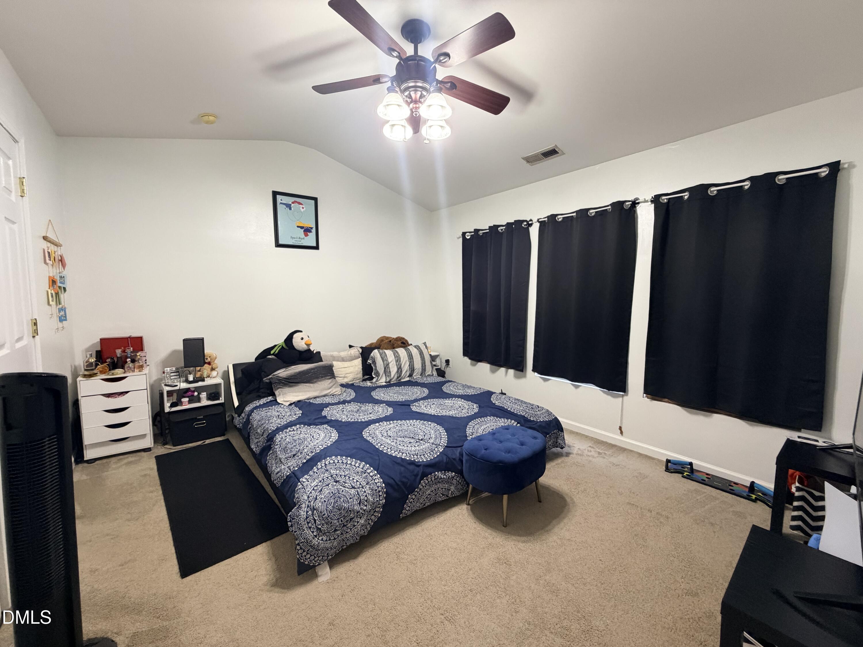 5345 Glen Canyon Road Raleigh, NC 27616 - Photo 15 of 21 a bed room with furniture and a flat screen tv