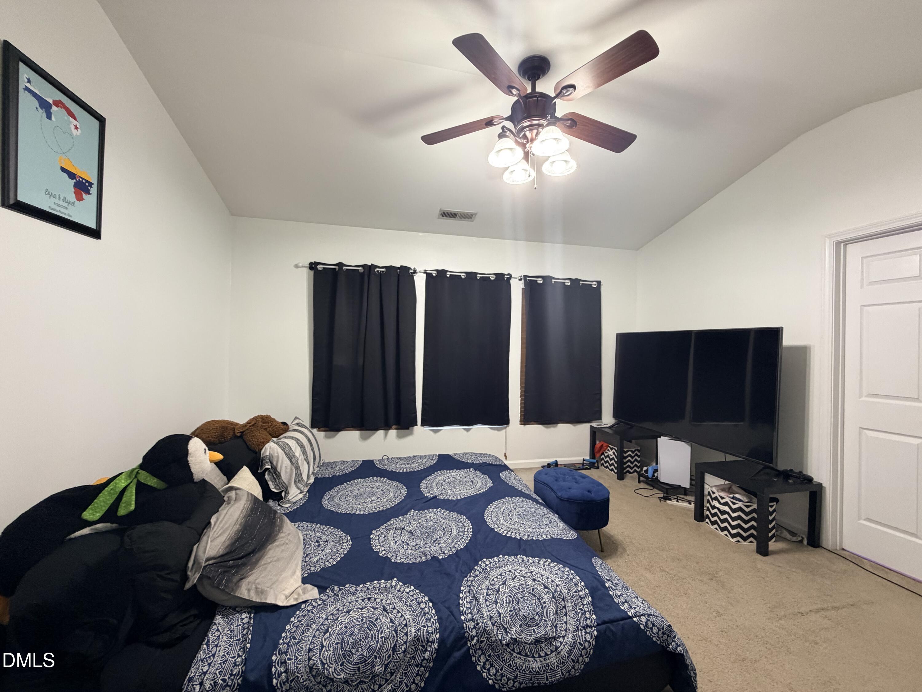 5345 Glen Canyon Road Raleigh, NC 27616 - Photo 16 of 21 a bedroom with furniture and a flat screen tv
