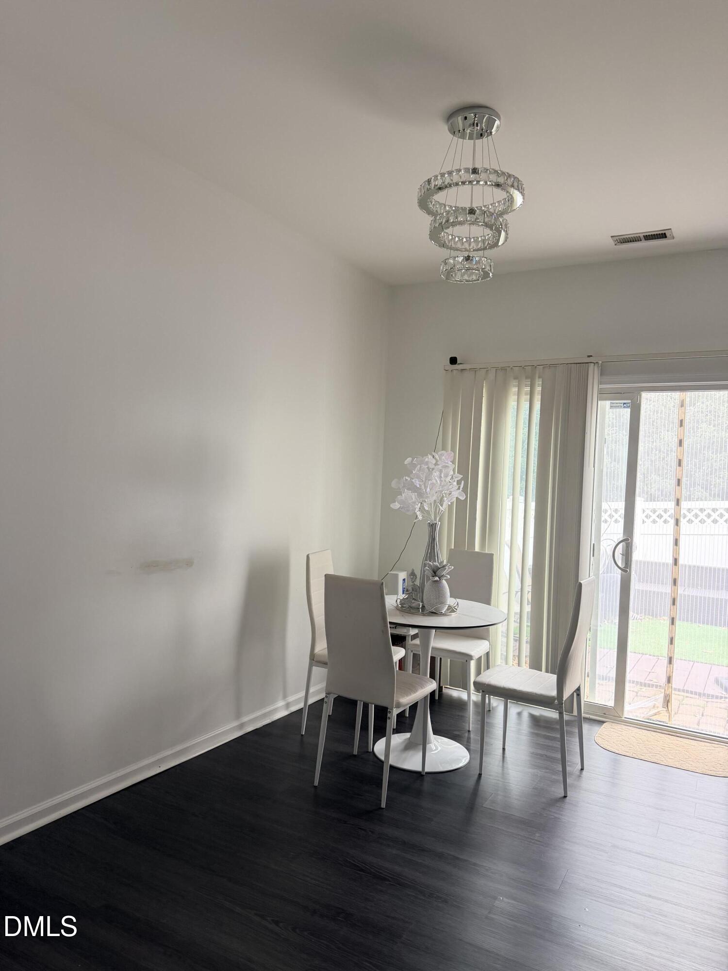 5345 Glen Canyon Road Raleigh, NC 27616 - Photo 4 of 21 a view of a dining room with furniture and wooden floor
