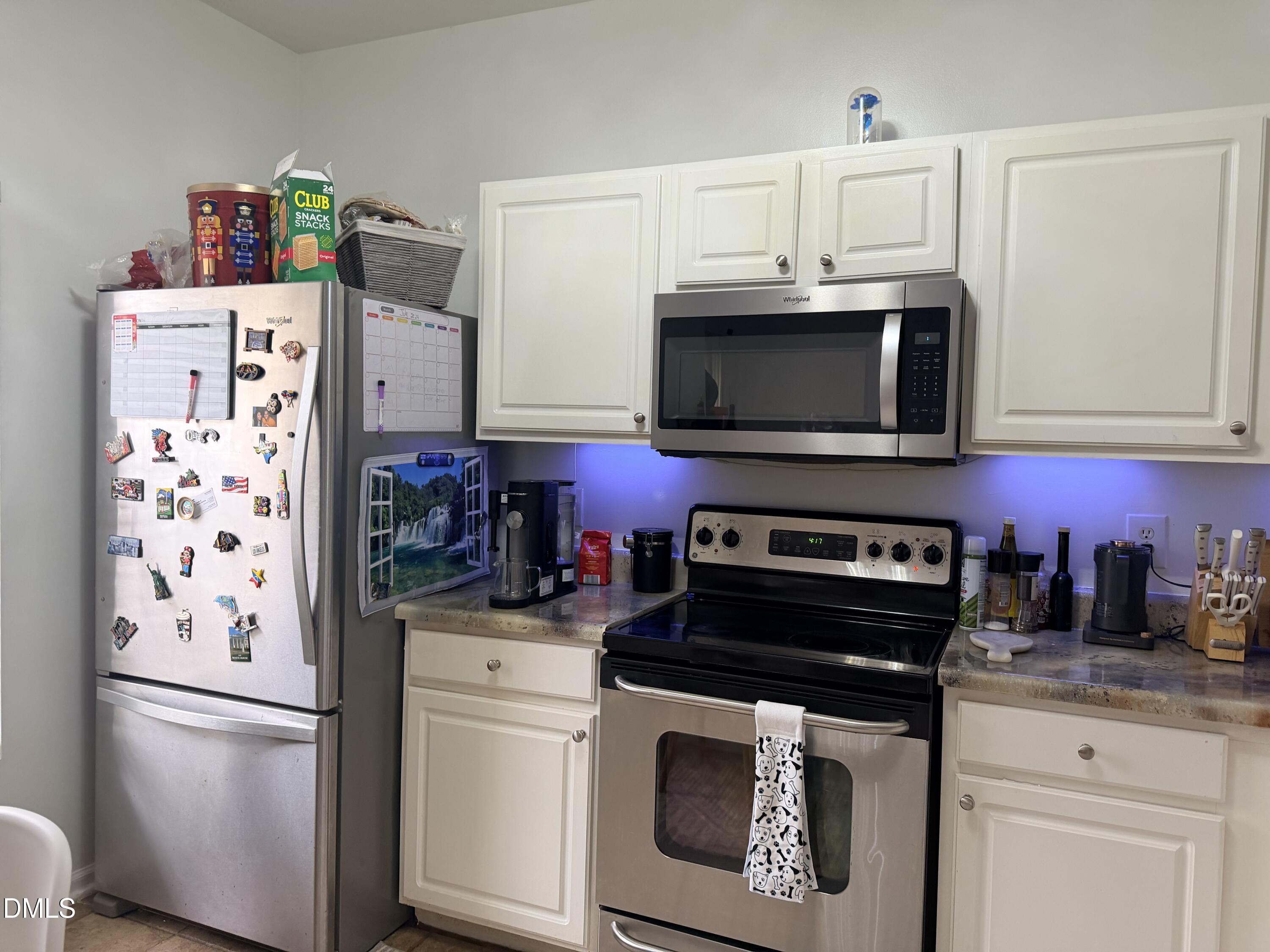 5345 Glen Canyon Road Raleigh, NC 27616 - Photo 8 of 21 a kitchen with stainless steel appliances a stove a refrigerator and cabinets