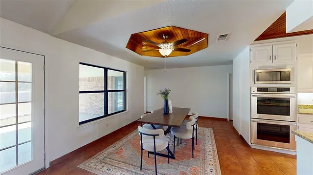 a dining room with furniture and window